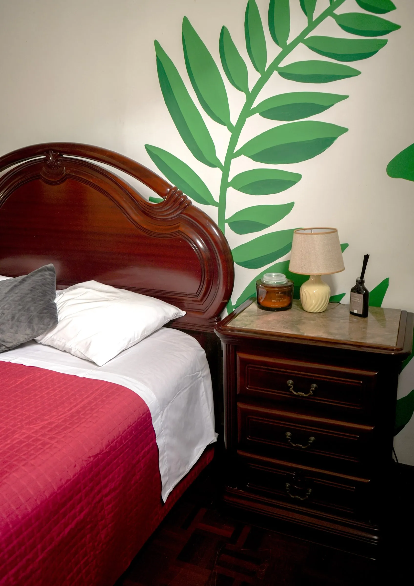 Fusilli bedside table beneath the painted banana leaves