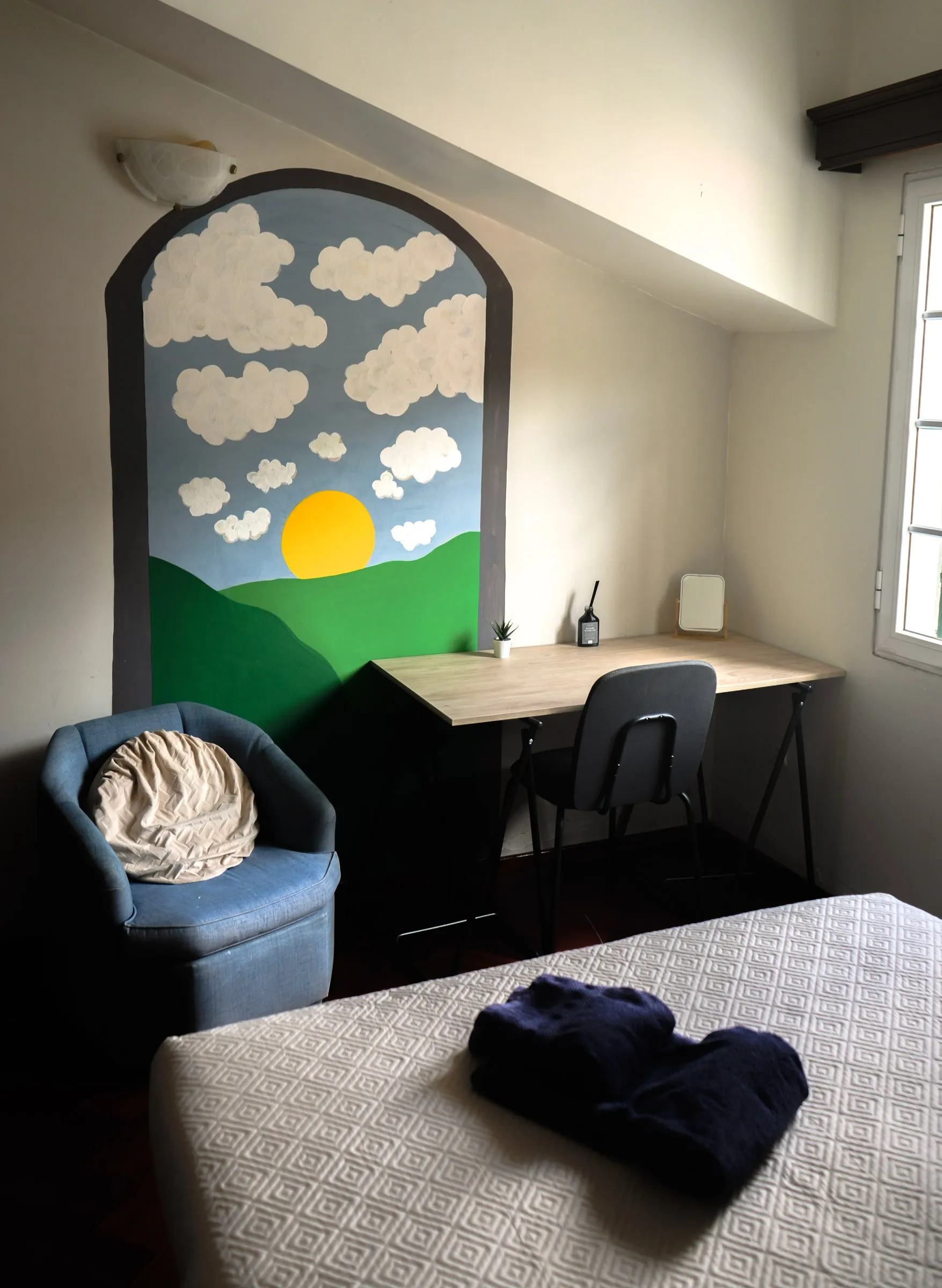 Orecchiette painted landscape, desk and blue armchair